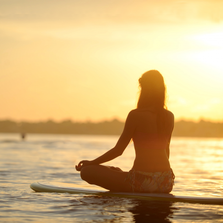 Girl on SUP Board doing Pilates